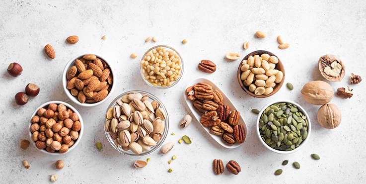 almonds, cashew nuts, walnuts, pine nuts in bowls