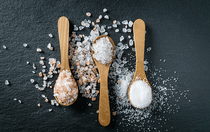 Image showing 3 different types of salt - Himalayan, sea salt and table salt. Relates to an article about the effects of salt on blood pressure and the heart.